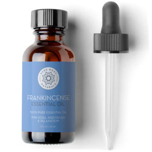 A brown glass bottle labeled "Frankincense Essential Oil, 1 fl oz" by Pure Body Naturals with a blue label. The text indicates it is 100% pure essential oil for yoga, meditation, and relaxation. The bottle is accompanied by a dropper on the right side.