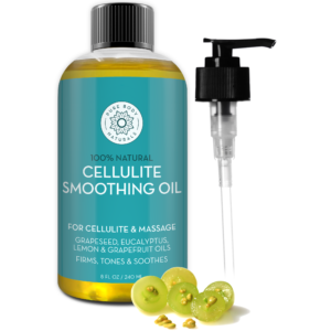 A bottle of 100% Natural Massage Oil from Pure Body Naturals, featuring a turquoise label and black pump dispenser, is shown alongside green grapes. The label highlights its natural ingredients: grapeseed, eucalyptus, lemon, and grapefruit oils. The bottle size is 8 fl oz (240 ml).