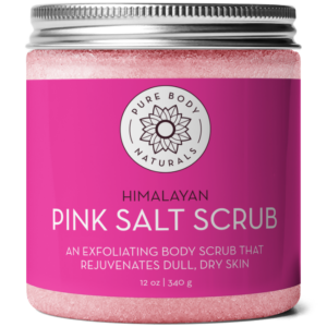 A jar of Himalayan Pink Salt Exfoliating Scrub, an exfoliating body scrub for rejuvenating dull, dry skin. The jar has a silver lid and the container is labeled with a pink and white design, indicating it contains 12 oz (340 g).
