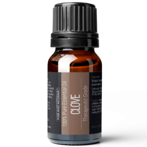 A 10 ml amber glass bottle of Clove Essential Oil, 10 ml labeled as clove, therapeutic grade. The bottle has a black ribbed cap and a detailed label that mentions ingredients and usage information.