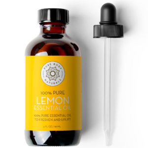 A brown glass bottle labeled "Lemon Essential Oil, 4 fl oz" with a yellow label and a floral design. The label also states "100% Pure Essential Oil to Freshen and Uplift" and "4 FL OZ / 118 ML". A glass dropper with a black rubber top is shown beside the bottle.